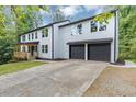 Stylish two-story home with a covered porch, modern windows, and a spacious driveway at 212 Lake Forest Dr, Acworth, GA 30102