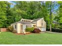 Charming home with a lush green lawn and mature trees providing ample shade and privacy at 2929 Alberta Dr, Marietta, GA 30062