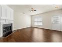 Cozy living room shows hardwood floors, a decorative fireplace, and plenty of natural light at 4100 Howell Park Rd, Duluth, GA 30096