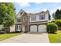 Beautiful two-story home featuring a stone facade, bay window, and an attached two-car garage at 935 Mill Creek Ave, Canton, GA 30115