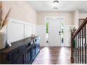 Bright foyer with hardwood floors, paneled walls, and a staircase with wrought iron spindles at 935 Mill Creek Ave, Canton, GA 30115