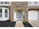 Inviting front entrance with stone accents, a welcome mat, and a well-manicured lawn at 935 Mill Creek Ave, Canton, GA 30115