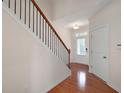 Inviting foyer featuring hardwood floors, a staircase with iron railings, and natural light at 1957 Brightleaf Way # 59, Marietta, GA 30060