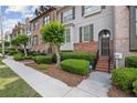 Inviting townhome exterior featuring brick accents, neat landscaping, and a secure ADT sign at 3133 Dunton Se St, Smyrna, GA 30080