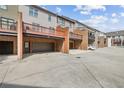 Townhome garages and rear entrances with brick accents and balcony views above at 3133 Dunton Se St, Smyrna, GA 30080