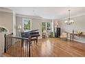 Elegant living room with hardwood floors, piano, and large windows filling the space with light at 3133 Dunton Se St, Smyrna, GA 30080