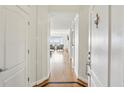 Bright hallway with hardwood floors leading to a modern living area at 3475 Oak Valley Ne Rd # 2060, Atlanta, GA 30326