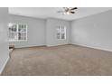 Spacious bedroom featuring plush carpet and two windows providing ample natural light at 3513 Newtons Crest Cir, Snellville, GA 30078