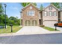 Beautiful home featuring a stone facade, two car garage, driveway, and well-manicured front yard at 4023 Caitlyn Pl, Atlanta, GA 30360