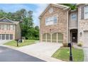 A home with stone facade, two car garage, driveway, front lawn and landscape at 4023 Caitlyn Pl, Atlanta, GA 30360
