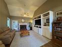 Cozy living room featuring a fireplace, built-in shelving, and neutral carpet at 4530 Bogan Gates Dr, Buford, GA 30519