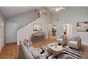 Bright and airy living room with vaulted ceilings, wood floors, and modern furnishings at 169 Parkside Dr, Stockbridge, GA 30281