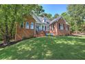Beautiful brick home with lush green lawn and mature trees at 3695 Highway 140, Rydal, GA 30171