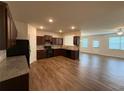 Open kitchen layout with hardwood floors, stainless steel appliances, and adjacent living space at 2335 Hackamore Dr, Atlanta, GA 30349