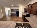 Open concept kitchen features granite counters, backsplash, and wood flooring at 2335 Hackamore Dr, Atlanta, GA 30349