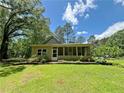 Well-maintained backyard featuring lush green lawn and a screened-in porch for outdoor enjoyment at 2520 Hollonville, Brooks, GA 30205