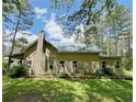 Charming home with green roof nestled among mature trees and a neatly manicured lawn at 2520 Hollonville, Brooks, GA 30205