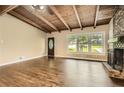 Spacious living room featuring hardwood floors, a cozy fireplace, and an abundance of natural light at 2648 Woodacres Ne Rd, Atlanta, GA 30345