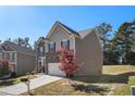 Side view of a two-story home with a stone front and neutral toned siding with mature landscaping at 3013 Nicholas Dr, Villa Rica, GA 30180