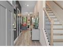 Inviting entryway with wood-look flooring, staircase, and views into the living area at 344 Navigator Ln, Mcdonough, GA 30253