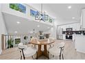 Dining area with modern lighting, a round wooden table, and bright, open space at 4058 Daron Ct, Ellenwood, GA 30294