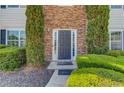 Beautiful stone entryway with a dark-colored front door and manicured bushes at 1043 Lexus Dr, Lawrenceville, GA 30045