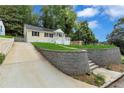 Well-manicured front yard features a retaining wall and driveway access to the street at 2084 Bethel Nw Dr, Atlanta, GA 30314