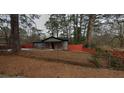 Charming single-story home with gray siding, an orange fence, and a well-maintained lawn at 3479 Thompson Nw Dr, Atlanta, GA 30331
