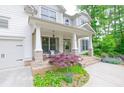 Inviting front porch with brick accents, stylish seating, and lush landscaping at 533 Beecham Dr, Smyrna, GA 30082