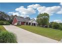 An exterior view showing the home's facade, driveway, and landscaped front yard on a sunny day at 825 Kennedy Ct, Loganville, GA 30052