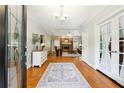 Inviting foyer with hardwood floors, elegant rug, chandelier, and a glimpse into the living room at 825 Kennedy Ct, Loganville, GA 30052