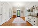 Bright entryway with hardwood floors, stylish decor, and a glass-paneled front door with sidelights at 825 Kennedy Ct, Loganville, GA 30052