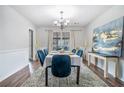 Dining room with neutral colors, hardwood floors, stylish chandelier, and a large window for natural light at 1625 Summit View Way, Snellville, GA 30078