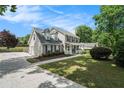 Well-maintained home with a spacious driveway, lush green lawn, and mature trees providing ample shade at 1625 Summit View Way, Snellville, GA 30078