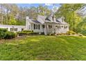 Inviting exterior with a charming porch and lush lawn at 1981 Luke Edwards Rd, Dacula, GA 30019