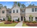 Desirable townhome community with brick and siding facades, lush lawns, and convenient walkways at 352 Navigator Ln, Mcdonough, GA 30253