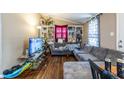 Relaxing living room with a large gray sectional sofa and hardwood floors at 120 Turman Se Ave, Atlanta, GA 30315