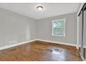 Bedroom featuring hardwood floors and a large window at 2417 Jade Dr, Lawrenceville, GA 30044