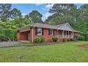 Brick home featuring an attached carport and lush green lawn at 2417 Jade Dr, Lawrenceville, GA 30044