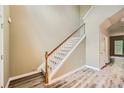 Bright foyer with staircase featuring wood handrail and gray carpet steps at 3733 Sidney Lanier Blvd, Duluth, GA 30096