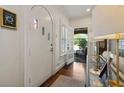 Welcoming entryway with a unique arched front door, hardwood floors, and views into the living area at 615 Wilson Nw Rd, Atlanta, GA 30318