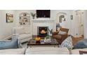 Cozy living room with a white painted fireplace, built-in shelves, and comfortable seating arrangement at 615 Wilson Nw Rd, Atlanta, GA 30318