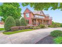 Lovely brick home with a covered porch, professional landscaping, and a curved driveway at 692 Heritage Post Ln, Grayson, GA 30017