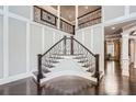 Grand foyer with curved staircase, decorative iron railings, and hardwood floors at 692 Heritage Post Ln, Grayson, GA 30017