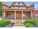 Charming covered front porch with double doors, stone steps, and wrought iron railings at 692 Heritage Post Ln, Grayson, GA 30017