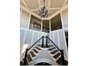 Elegant staircase with decorative iron railings and trim leading to the second floor at 692 Heritage Post Ln, Grayson, GA 30017