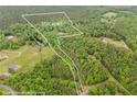 An aerial view of property lines bordering a large plot of land with dense trees and open fields at 7 Perkins Mountain Rd, Kingston, GA 30145