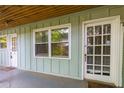 Charming exterior with pale green siding, white trim, and natural wood porch ceiling at 986 Greenwood Ne Ave # 4, Atlanta, GA 30306