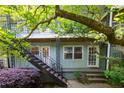 Apartment exterior with a black metal stairway and lush foliage surrounding the building at 986 Greenwood Ne Ave # 4, Atlanta, GA 30306