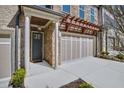 Welcoming entryway featuring stone accents, an attached garage, and manicured landscaping at 116 Via Roma, Woodstock, GA 30188